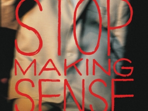 A movie poster for the re-release of Stop Making Sense shows a blurry still of David Byrne in a suit.