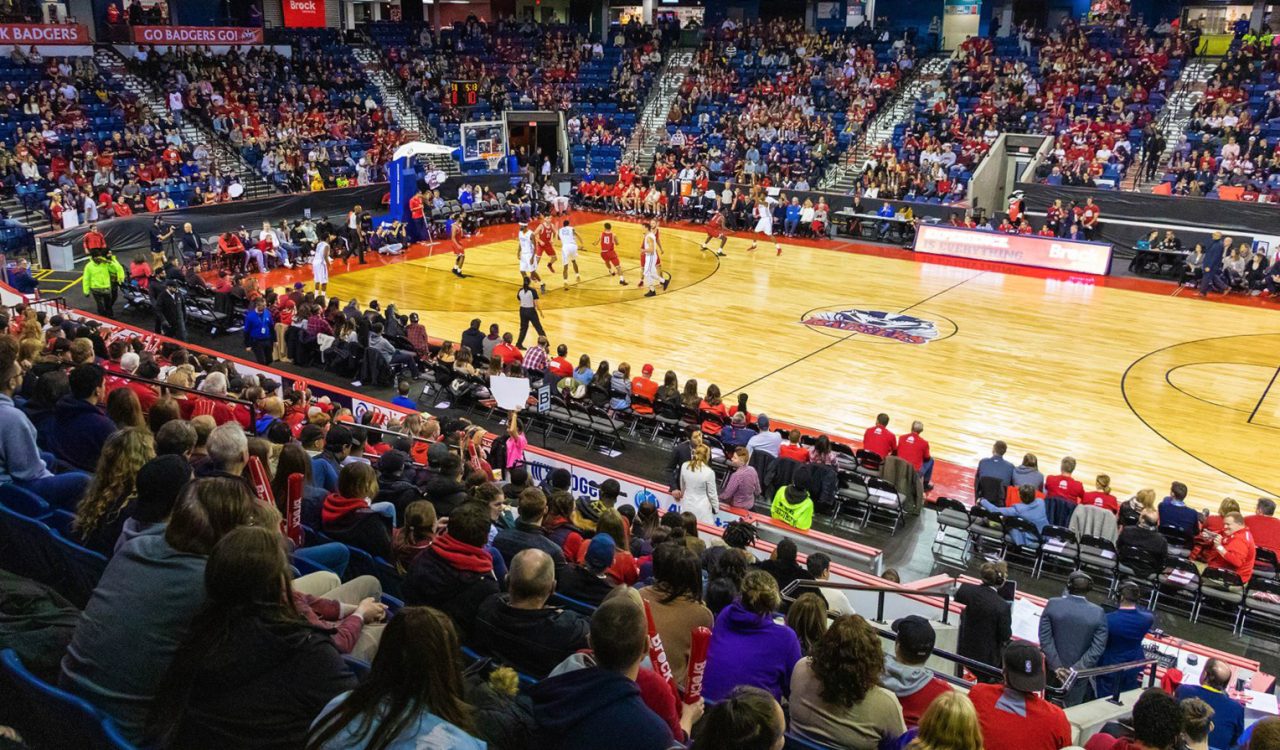 An arena full of fans watch a basketball game in St. Catharines.