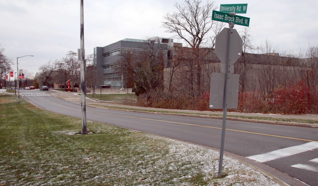 A street signs sits on the corner of an intersection at Brock University.