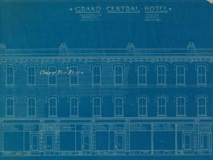 An architect’s drawing titled, Grand Central Hotel of a three-floor building with the words omit top floor written across the third floor of the design.