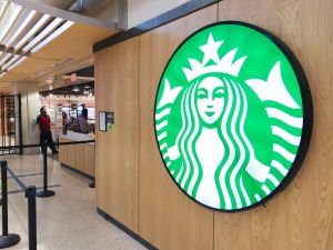 Exterior shot of Market Eatery entrance with illuminated Starbucks logo in the foreground.