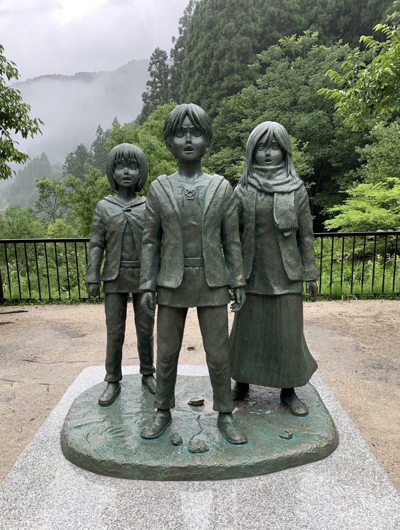 bronze statue of three Attack on Titan anime characters in Hita, Japan