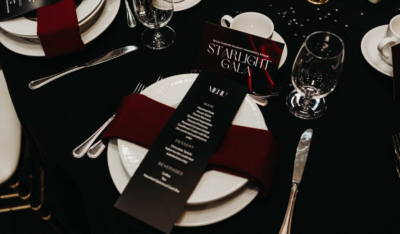 A close-up of a dinner setting on a formal table at a gala.