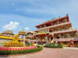 The colourful façade of a Chinese Buddhist temple in Thailand on a sunny day.