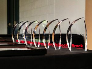 A row of glass awards on a table.