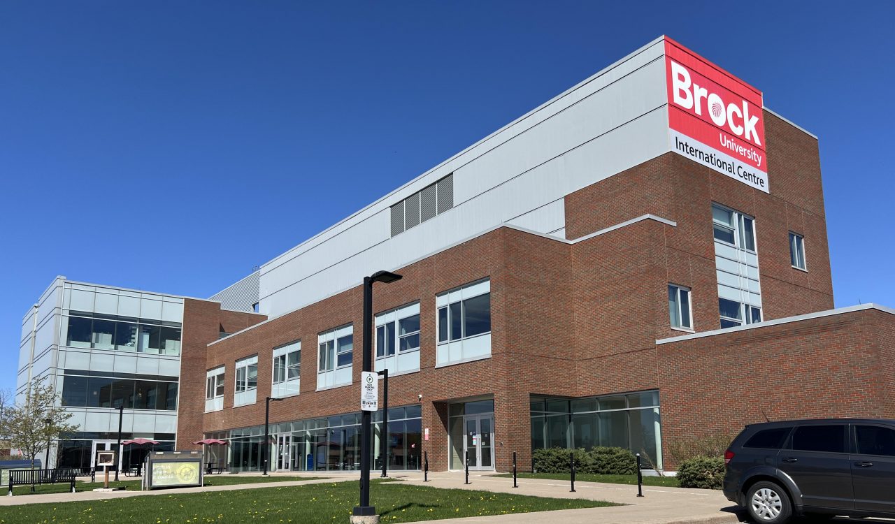 A photo of the Brock University International Centre building exterior in front of a blue sky on a sunny day.
