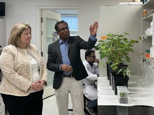 Cool Climate Oenology and Viticulture Institute Principal Scientist Sudarsana Poojari describes plant specimens in a lab space to Ontario’s Minister of Agriculture, Food and Rural Affairs Lisa Thompson.
