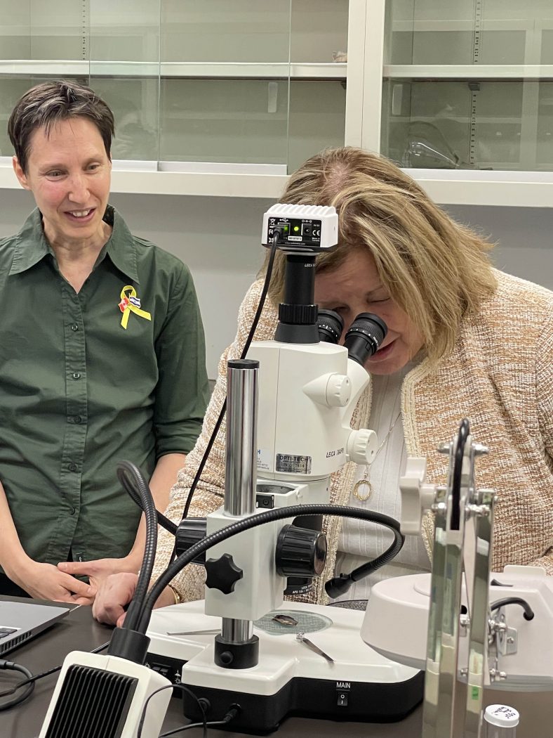 Malkie Spodek, Entomology Scientist with Brock’s Cool Climate Oenology and Viticulture Institute and Adjunct Professor in Biological Sciences, looks on as Ontario’s Minister of Agriculture, Food and Rural Affairs Lisa Thompson examines an insect specimen through a microscope.