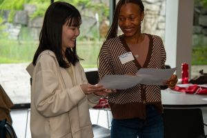 ESL students Rena Oka and Animatou Souare participate in an ice breaker game during ESL Spring orientation.