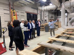 A group of people of people tour a university facility.