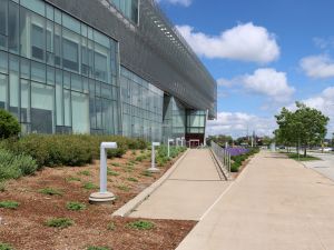 A photo of the ramp leading up to the entrance to Brock University’s Roy and Lois Cairns Health and Bioscience Research Complex building.