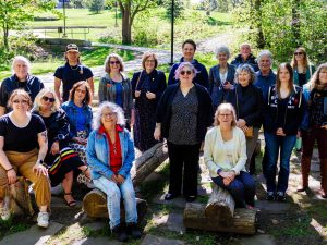 A group of leaders pose of a photo amongst nature outdoors at Brock University.