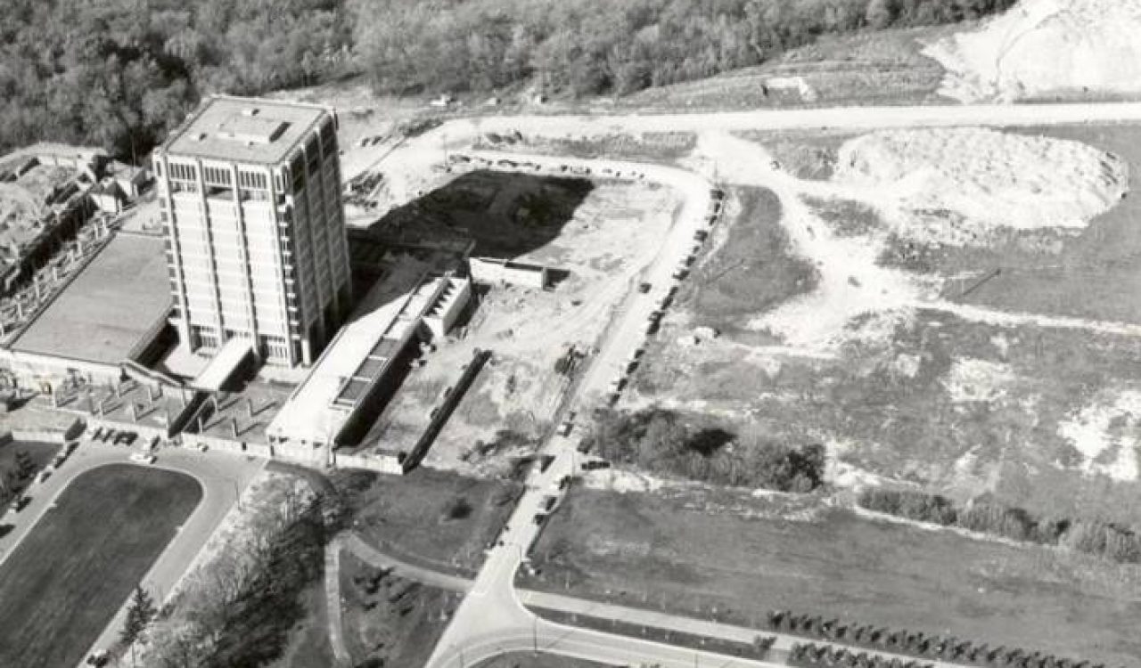 A black and white aerial photo of a property with a large concrete tower on it.