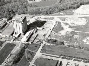 A black and white aerial photo of a property with a large concrete tower on it.