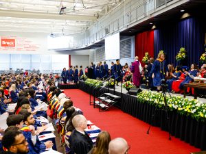 A wide angle view of the crowd watching new graduates cross the convocation stage at Brock University.