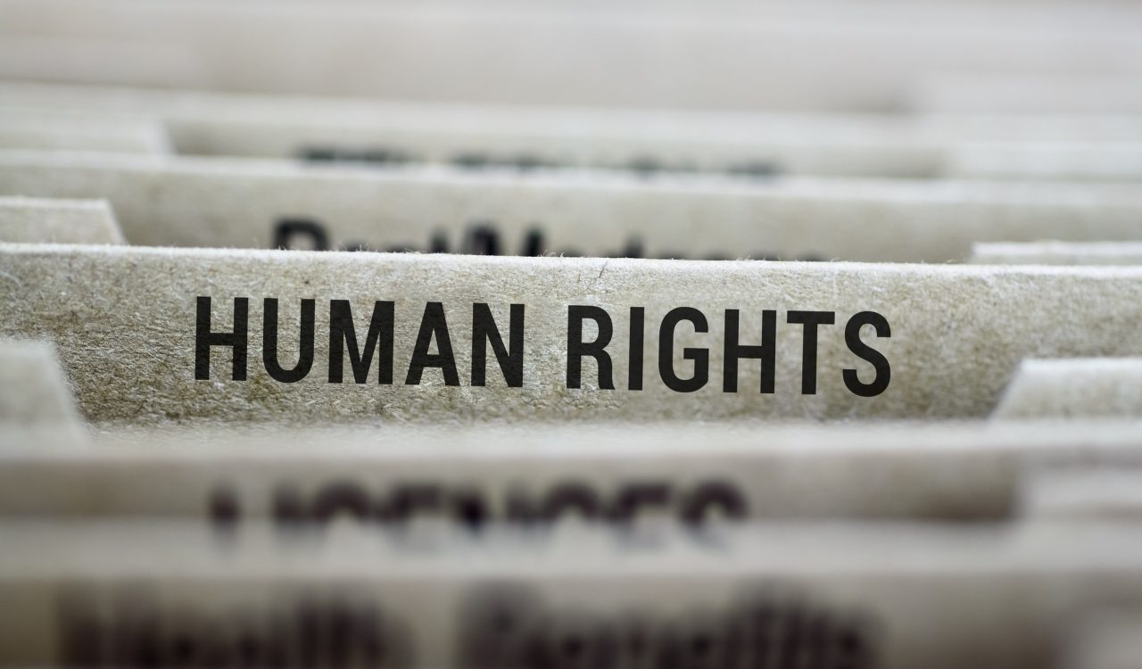 A folder labelled "Human rights" sits in a filing cabinet alongside other folders with unreadable names.