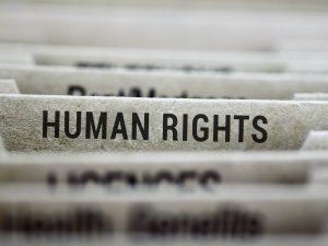 A folder labelled "Human rights" sits in a filing cabinet alongside other folders with unreadable names.