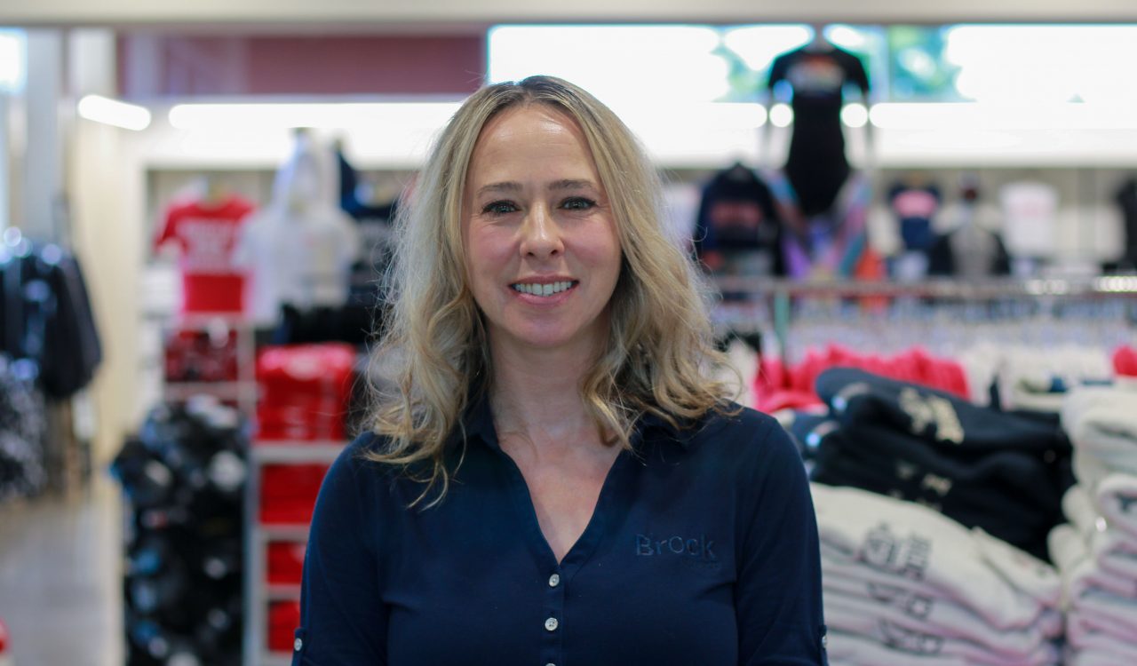 A woman poses for a photo in a store.