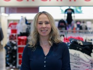 A woman poses for a photo in a store.