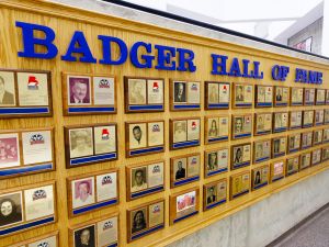 A wall displays plaques of athletes and builders for the Brock University varsity athletics Hall of Fame.