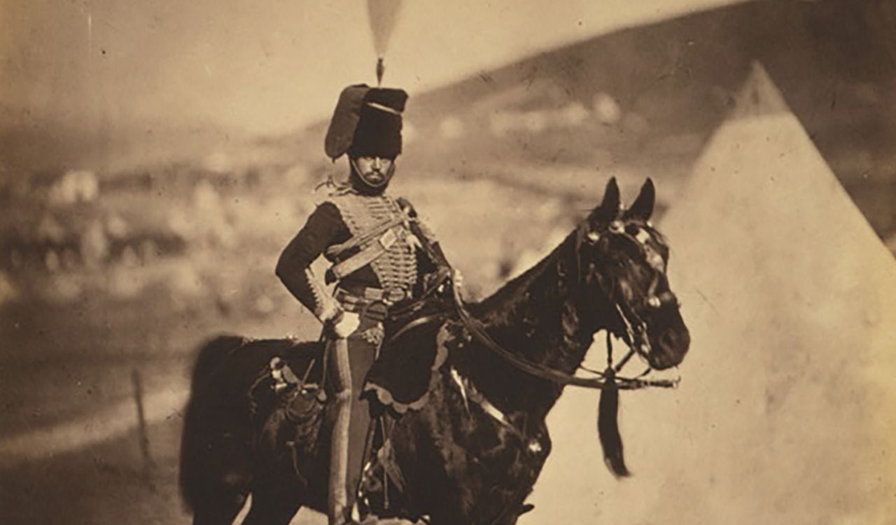 A historic image of a soldier on a horse.