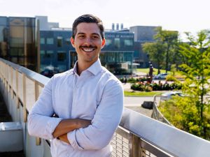 Jacob Forlin poses for a photo on a balcony overlooking the Brock University campus.