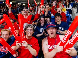 A crowd of people in an arena wearing Brock University gear.