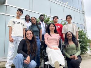 Brock University’s nine international student ambassadors pose for a group photo outside of the Brock International Centre building.