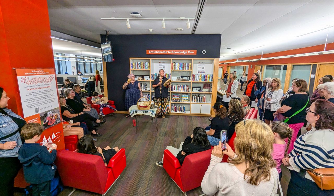 Robyn Bourgeois stands with Nicole Joy-Fraser after performing a song and drumming at the opening of Brock’s Entiohahathe'te Knowledge Den on Sept. 24 in the University’s Library in front of a group of adults and children.