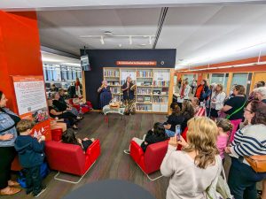 Robyn Bourgeois stands with Nicole Joy-Fraser after performing a song and drumming at the opening of Brock’s Entiohahathe'te Knowledge Den on Sept. 24 in the University’s Library in front of a group of adults and children.