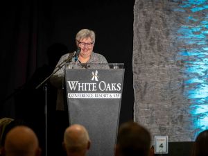 Brock University’s Provost and Vice-President, Academic Arja Vainio-Mattila smiles while delivering a speech behind a podium.