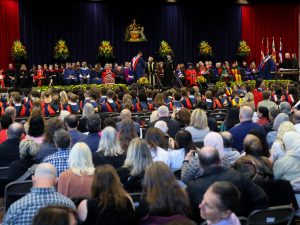 A gymnasium packed with graduates and their families celebrating Convocation.