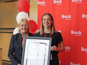 Ingrid Makus and Ornella Marinic with a framed Distinguished Faculty Graduate Award.