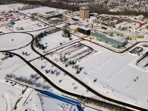 An aerial view of the Brock University campus in winter along Isaac Brock Boulevard.