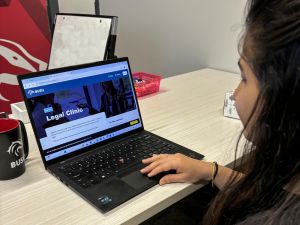 An over-the-shoulder view of a person looking at a website on a laptop.