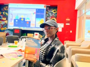 A university student holds up a book during an international show and tell event,