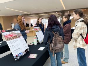 University students at a booth during an international education fair.