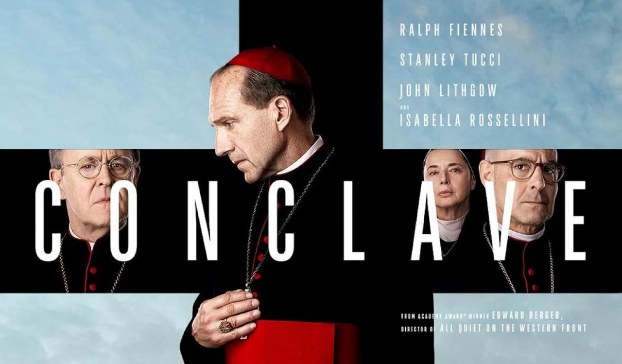 Movie poster for Conclave shows Ralph Fiennes and other actors forming a black cross against a background of the sky over the Vatican.