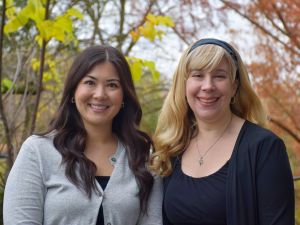 Assistant Professor Ann Farrell and Associate Professor Danielle Sirianni Molnar, with late fall foliage behind Thistle Complex at Brock University.