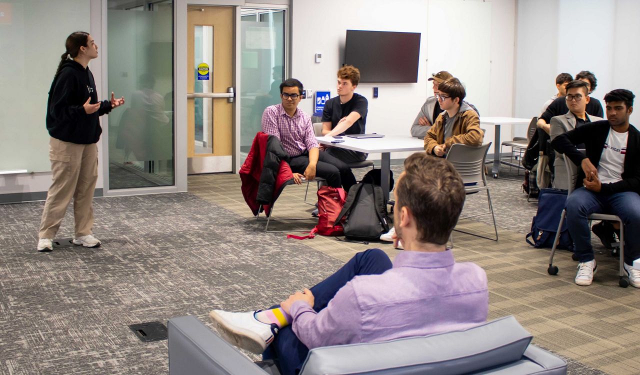 Goodman School of Business student pitches her entrepreneurial idea to Dragon’s Den entrepreneur, Alex Peters, at campus event with fellow peers.