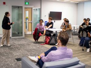 Goodman School of Business student pitches her entrepreneurial idea to Dragon’s Den entrepreneur, Alex Peters, at campus event with fellow peers.