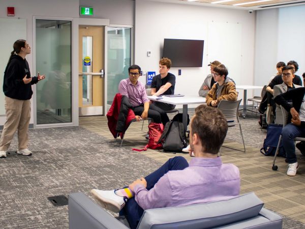 Goodman School of Business student pitches her entrepreneurial idea to Dragon’s Den entrepreneur, Alex Peters, at campus event with fellow peers.