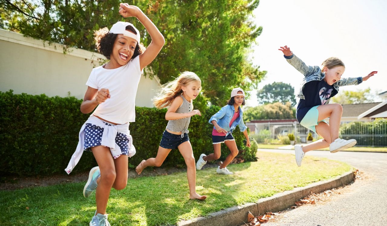 Group of children having fun moving outdoors on a summer day.