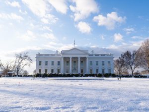 A horizontal photo of the north side of the White House blanketed in snow.