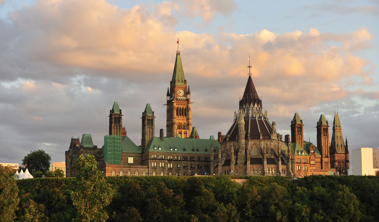 The Parliament buildings in Ottawa seen at sunset from across the Ottawa river.