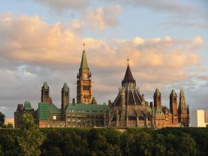 The Parliament buildings in Ottawa seen at sunset from across the Ottawa river.