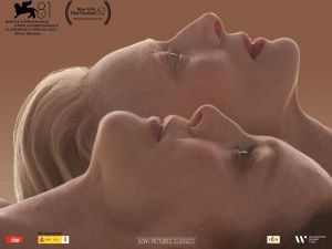 A movie poster for The Room Next Door features the faces of stars Tilda Swinton and Julianne Moore in profile and looking upward.