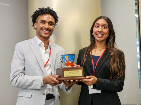 Brock students Solomon Mike (left) and Harman Kaur (right) hold up the O’Malley Cup trophy.