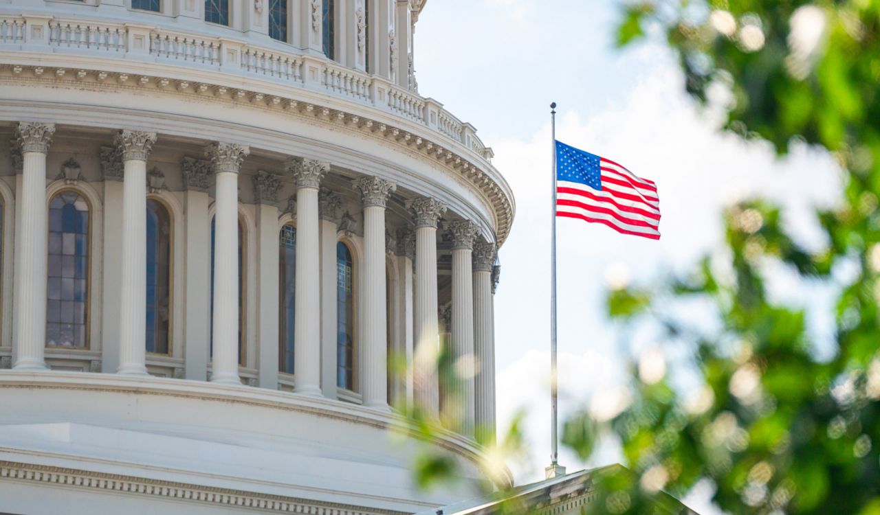 The U.S. flag flies in front of the Capitol building in Washington D.C.