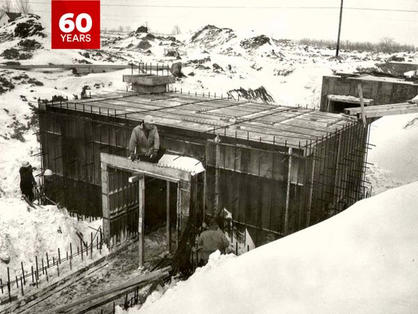 A black-and-white photograph of a tunnel system being constructed below ground.